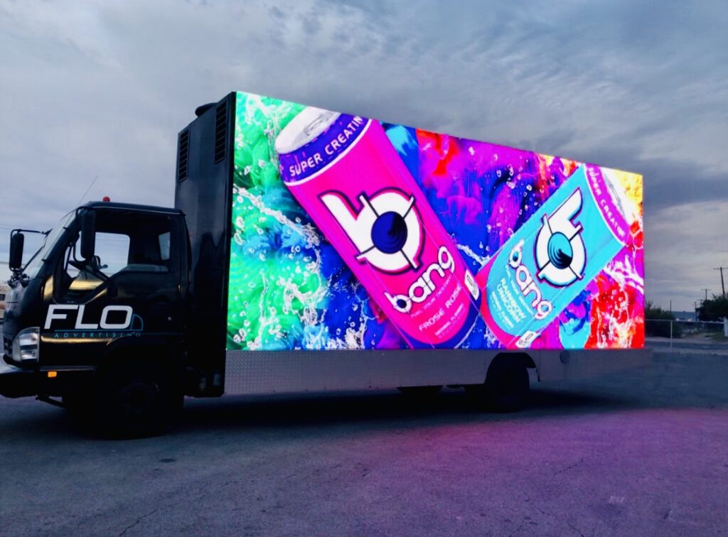 A billboard truck with a Bang energy drink logo on it.